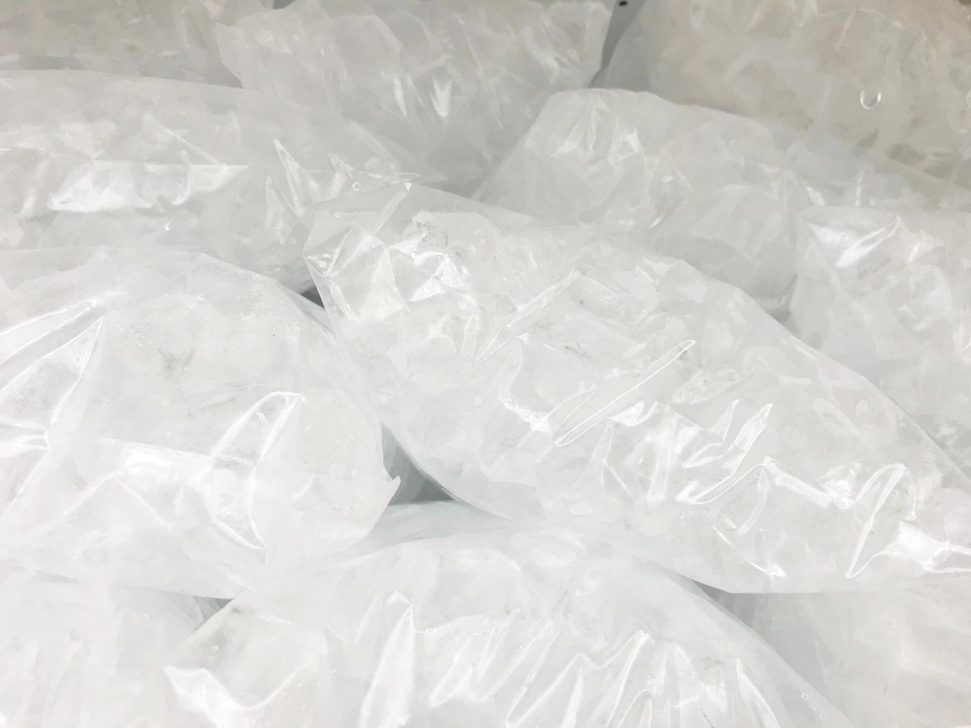 A Pile of Clear Plastic Bags Filled With Ice Cubes Stacked Together — Cool Blue Ice & Water in Armidale, NSW