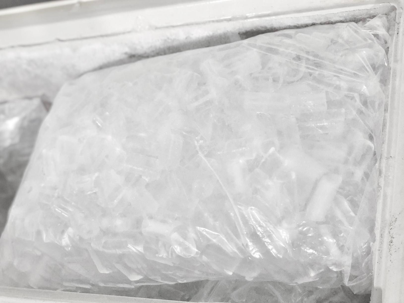 A Clear Plastic Bag Filled With Cylindrical Ice Cubes — Cool Blue Ice & Water in Taminda, NSW