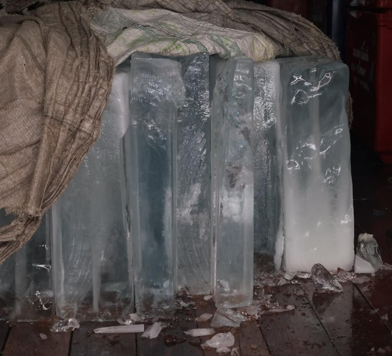 Large Ice Blocks Stacked Outdoors Beside a Draped Blanket — Cool Blue Ice & Water In Muswellbrook, NSW