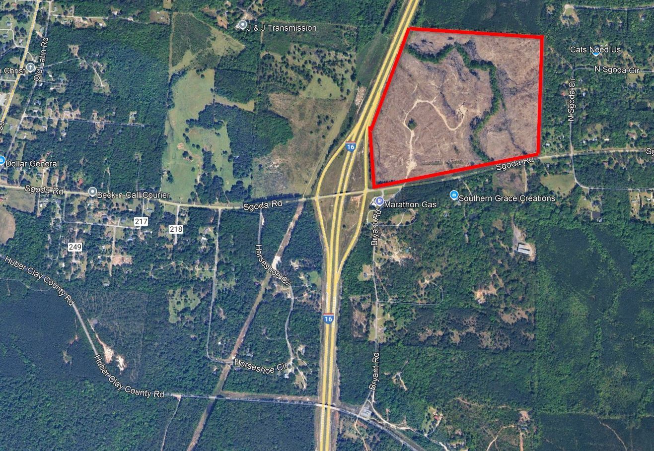 An aerial view of a road with a red circle around it.