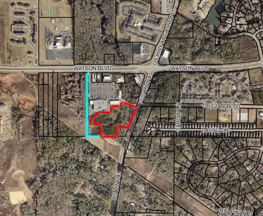 An aerial view of a residential area with a red circle in the middle.