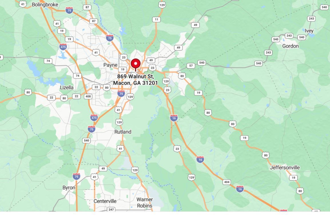 Map screenshot with a red location pin centered on a town in a green, mountainous area