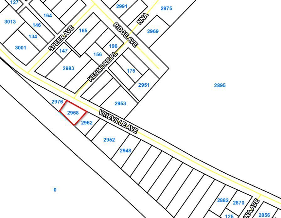 Parcel map with lot outlines, blue lot numbers, and one red-highlighted parcel along a street.