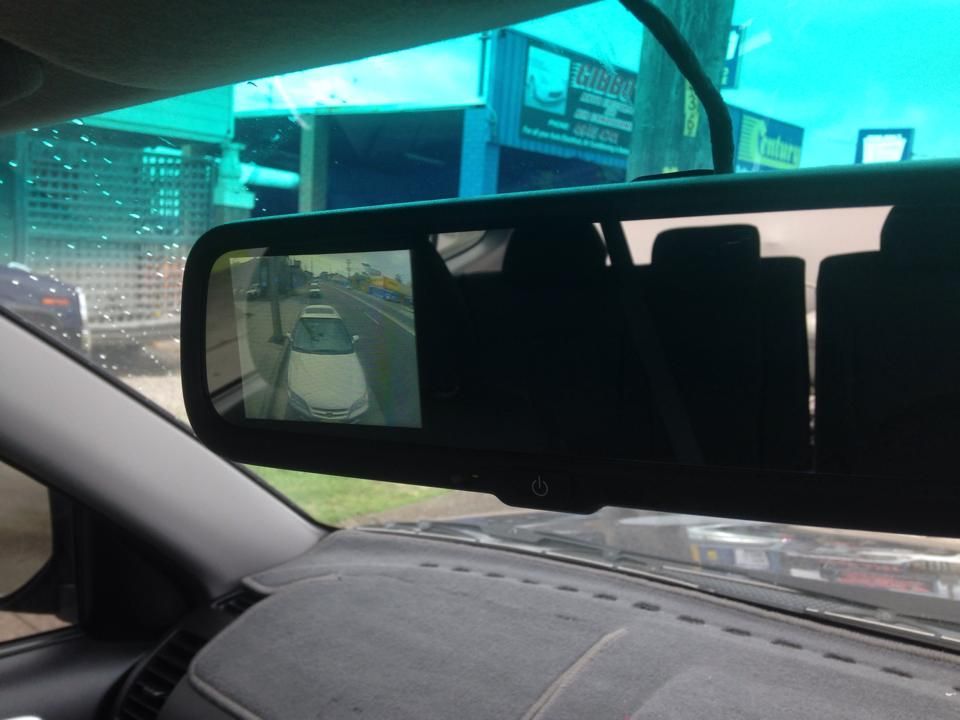 Rear View Mirror Displaying a Car Following — Gibbo's Auto Electrics & Air Conditioning Services in Lake Macquarie, NSW