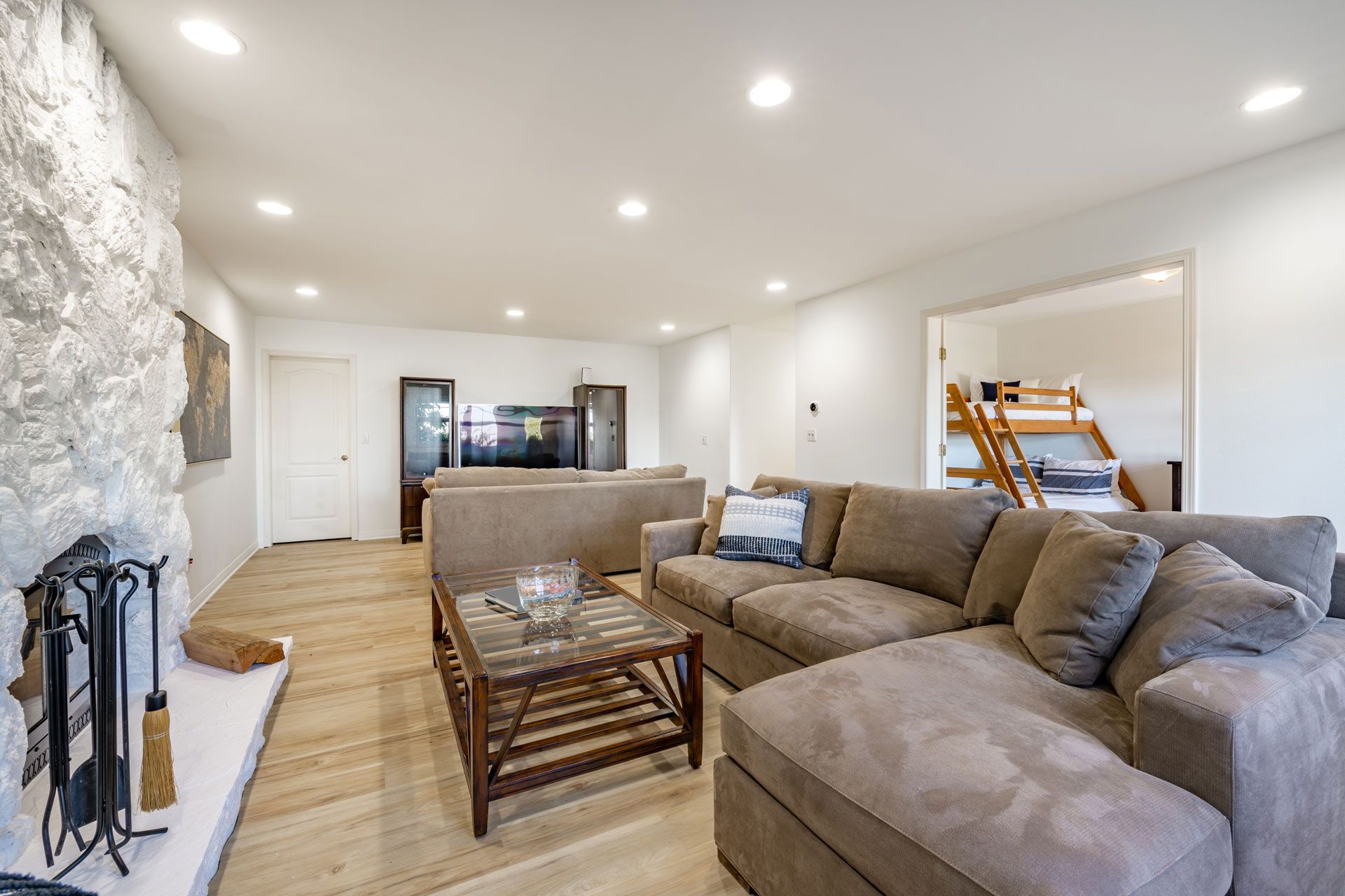 A living room with a couch , coffee table and fireplace.