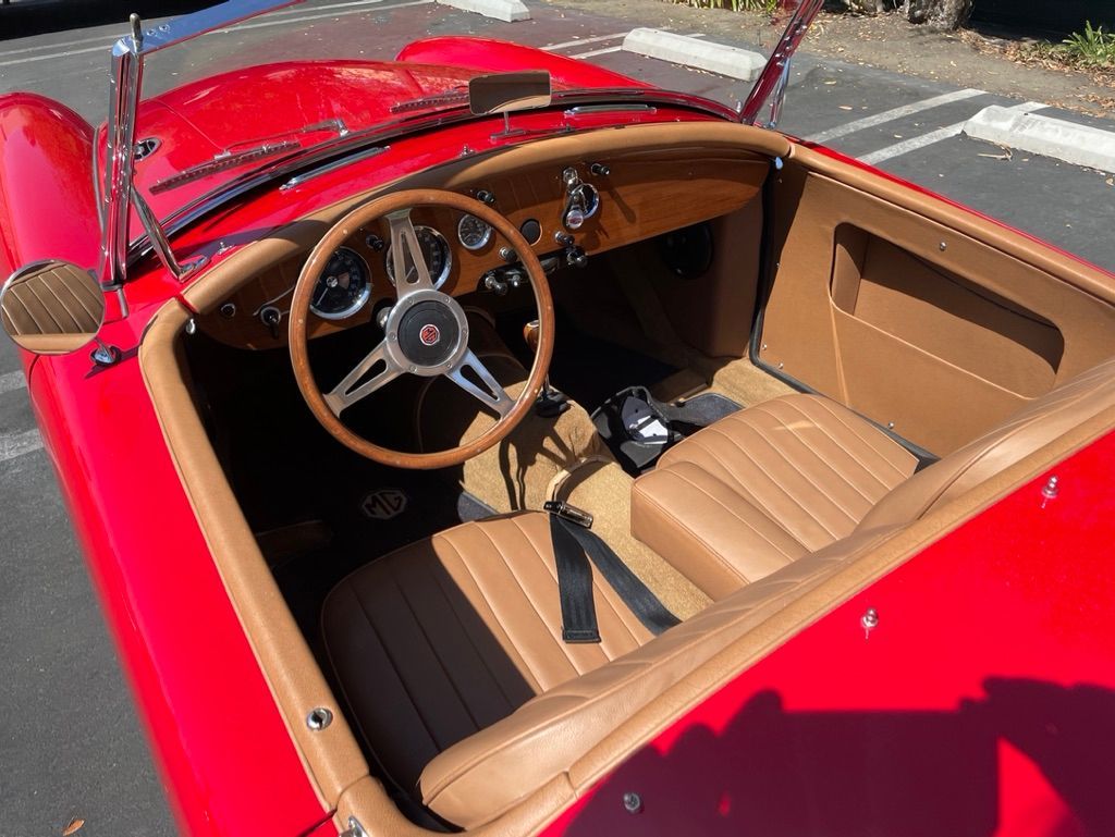 Interior of a black pickup truck with a steering wheel, seats, and center console.