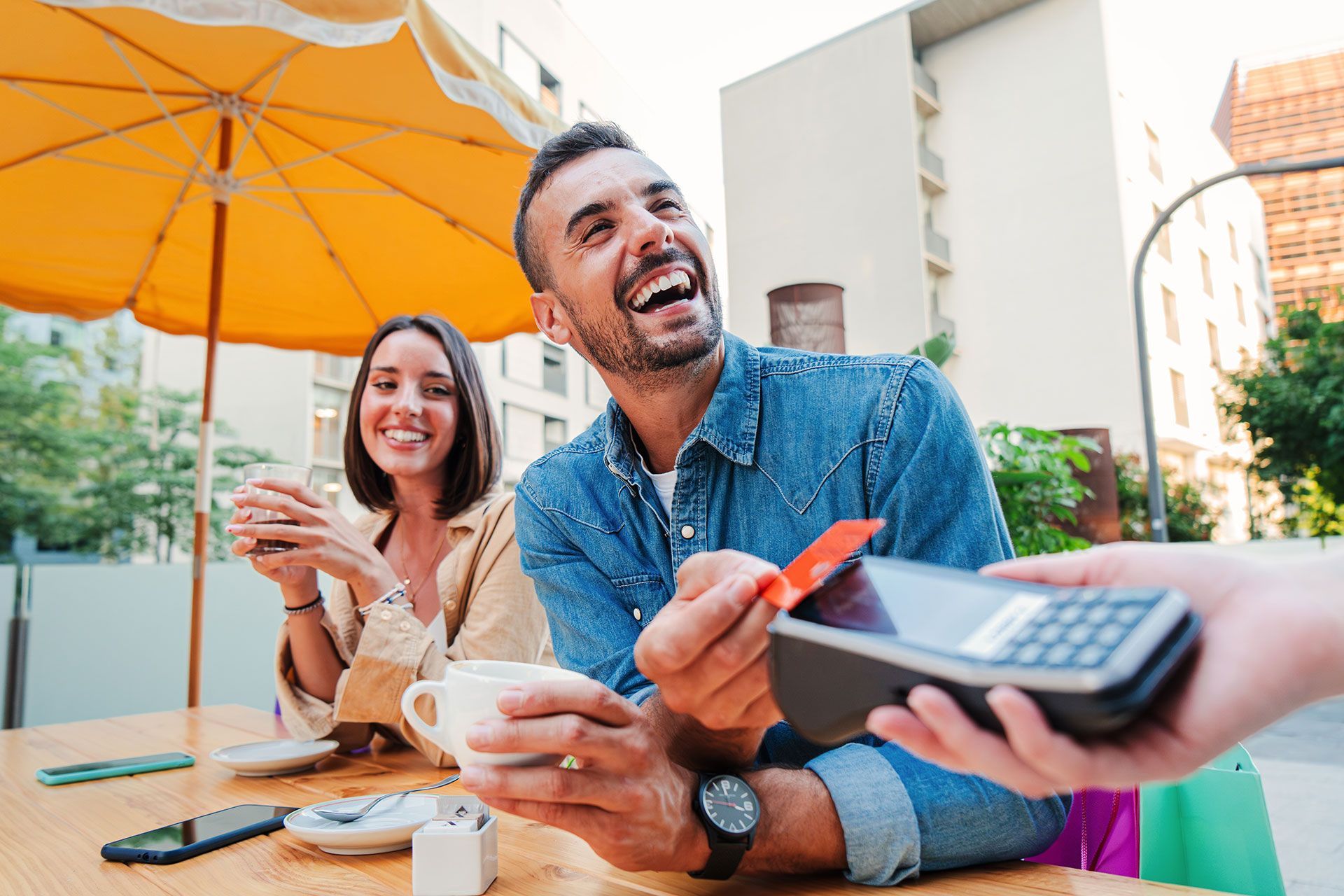 A man is paying with a credit card at a restaurant.