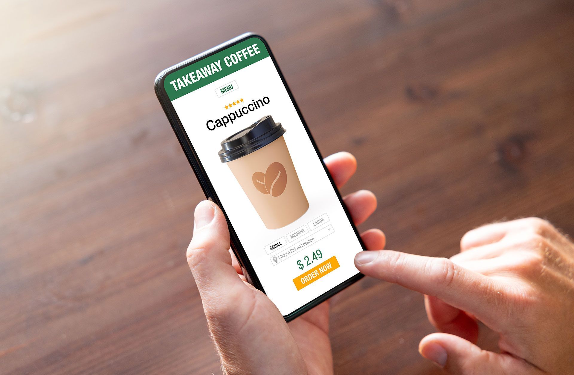 A person is holding a cell phone with a cup of coffee on the screen.