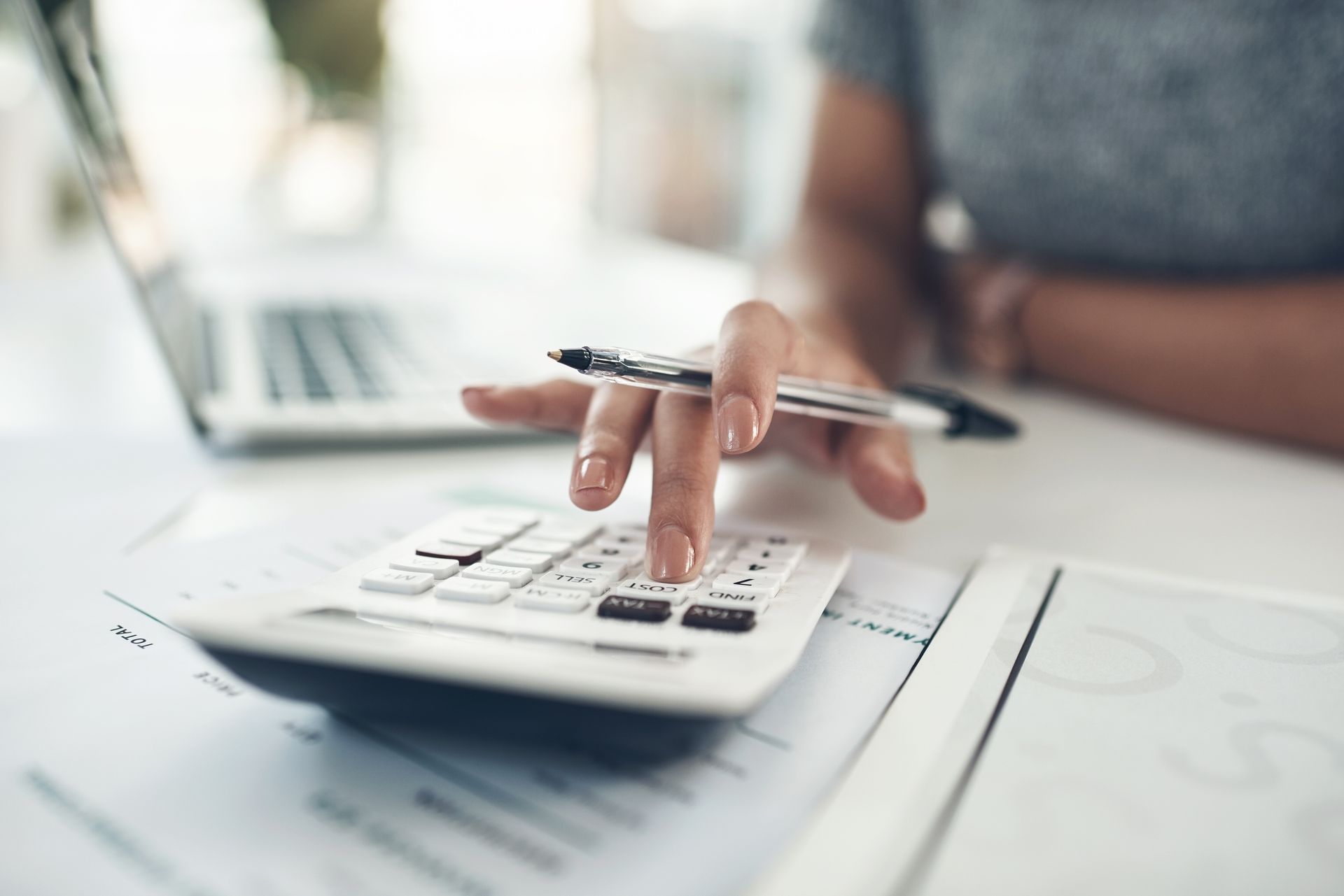 A woman is using a calculator.