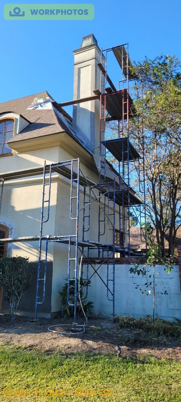 House exterior with scaffolding and a tall white chimney under a clear blue sky