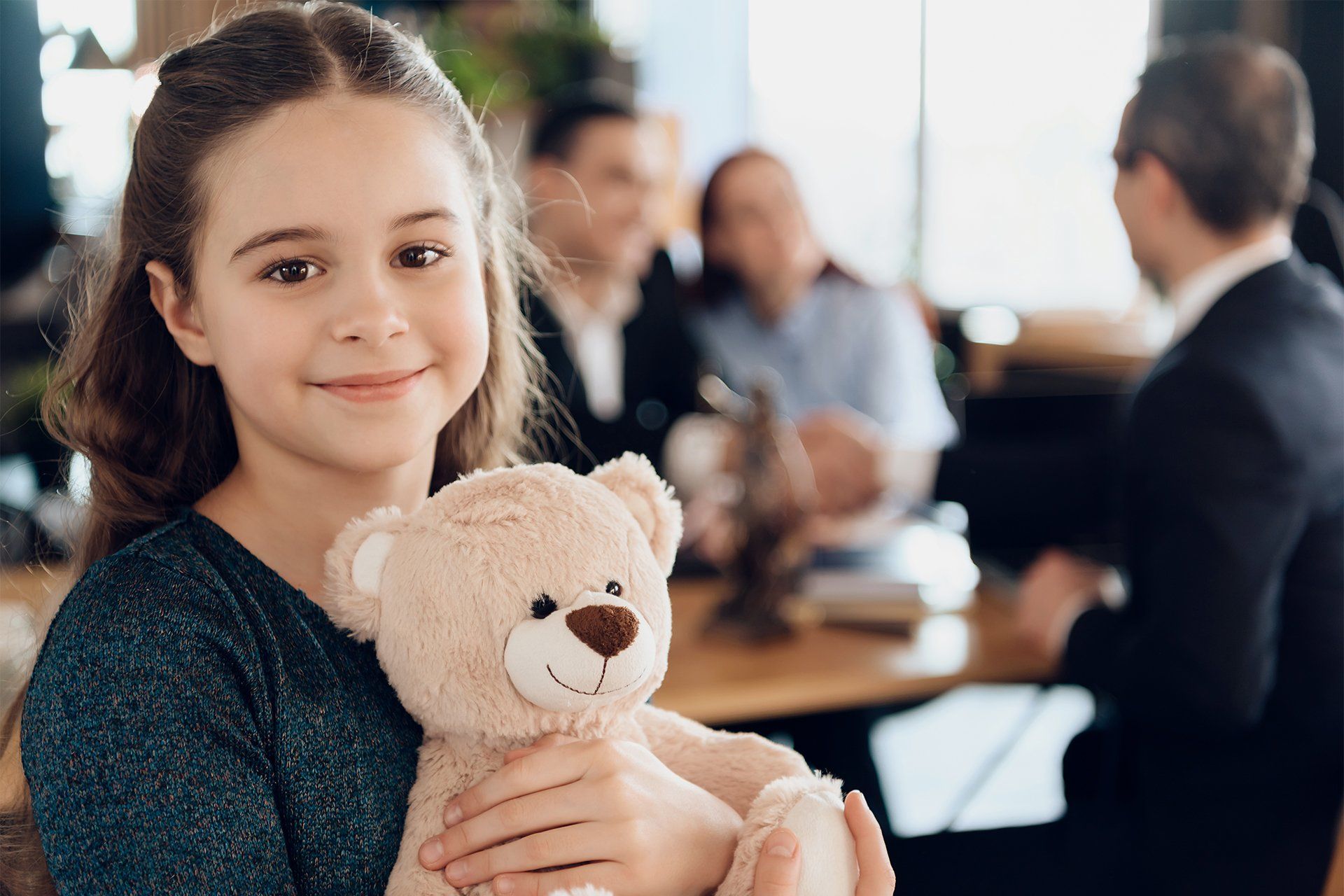 Little Girl Hugging Her Teddy Bear at Lawyer Office