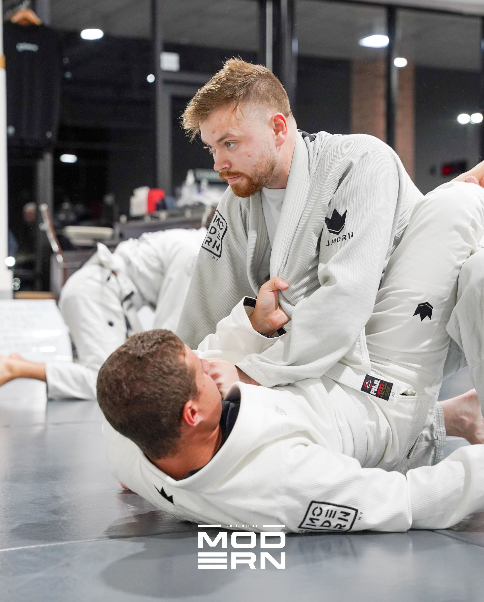 Adults practicing Brazilian Jiu-Jitsu at Jiu-Jitsu Modern in North Babylon, NY to build fitness.