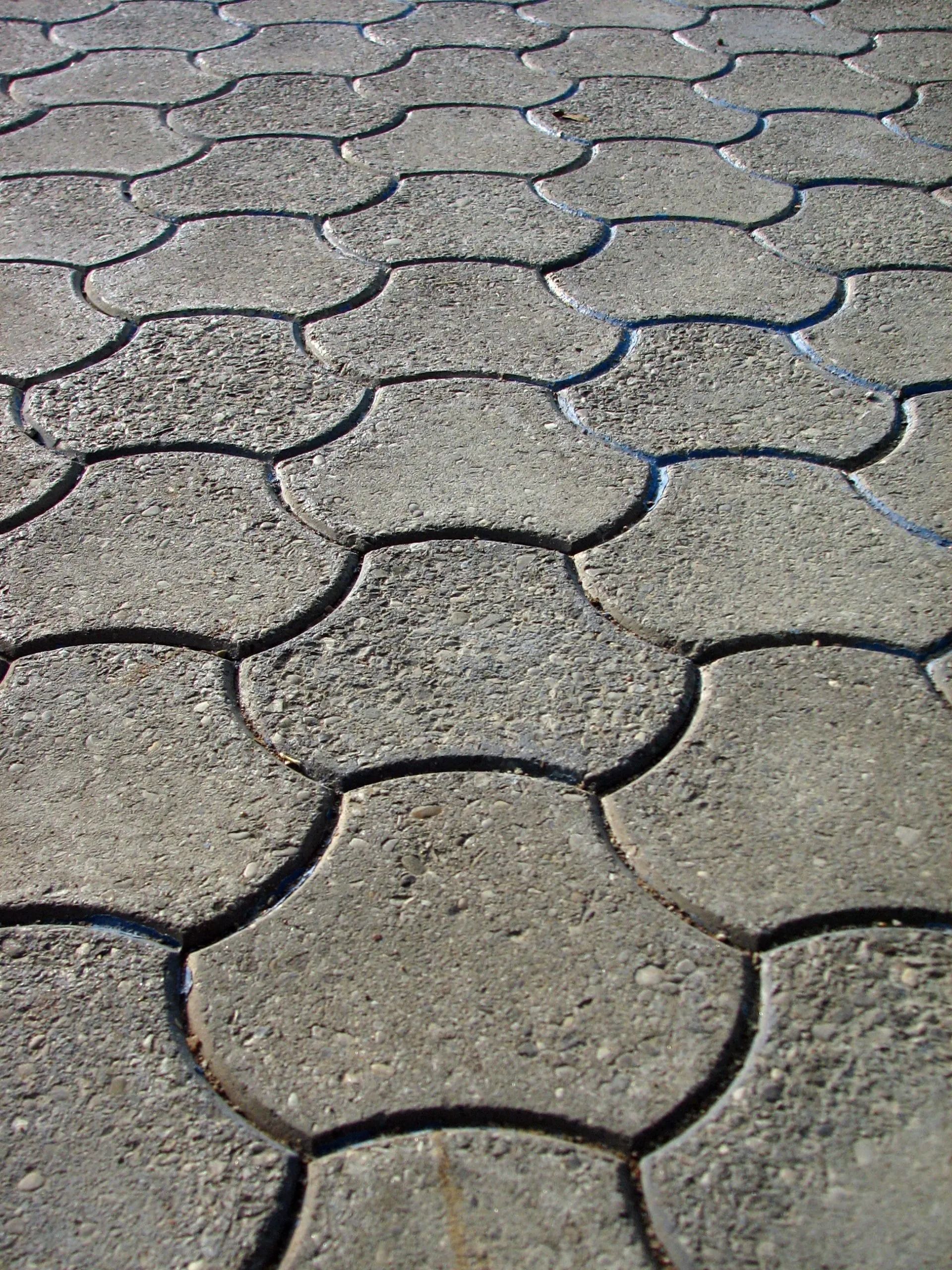 A close up of a brick floor with a geometric pattern