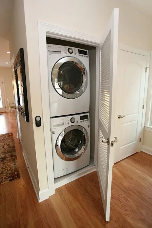 A washer and dryer are stacked on top of each other in a closet.