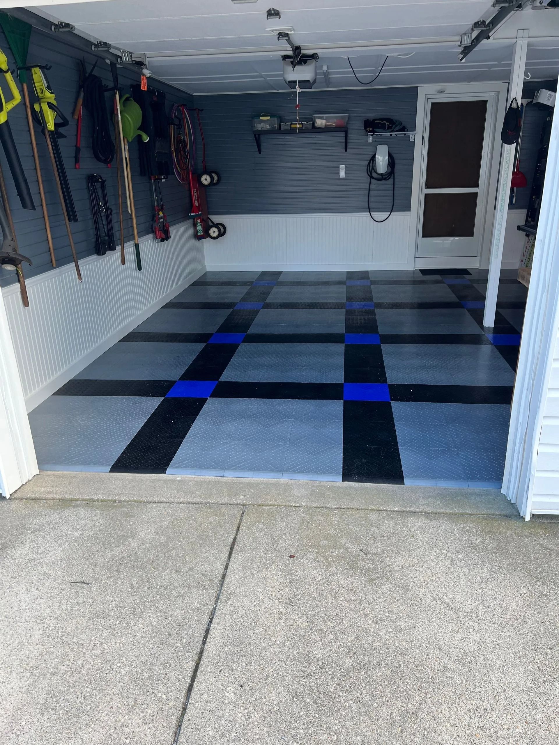 A garage with a blue and black checkered floor.