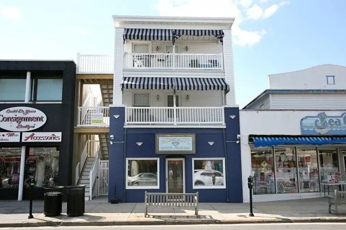 A blue and white building with a sign that says assignment day