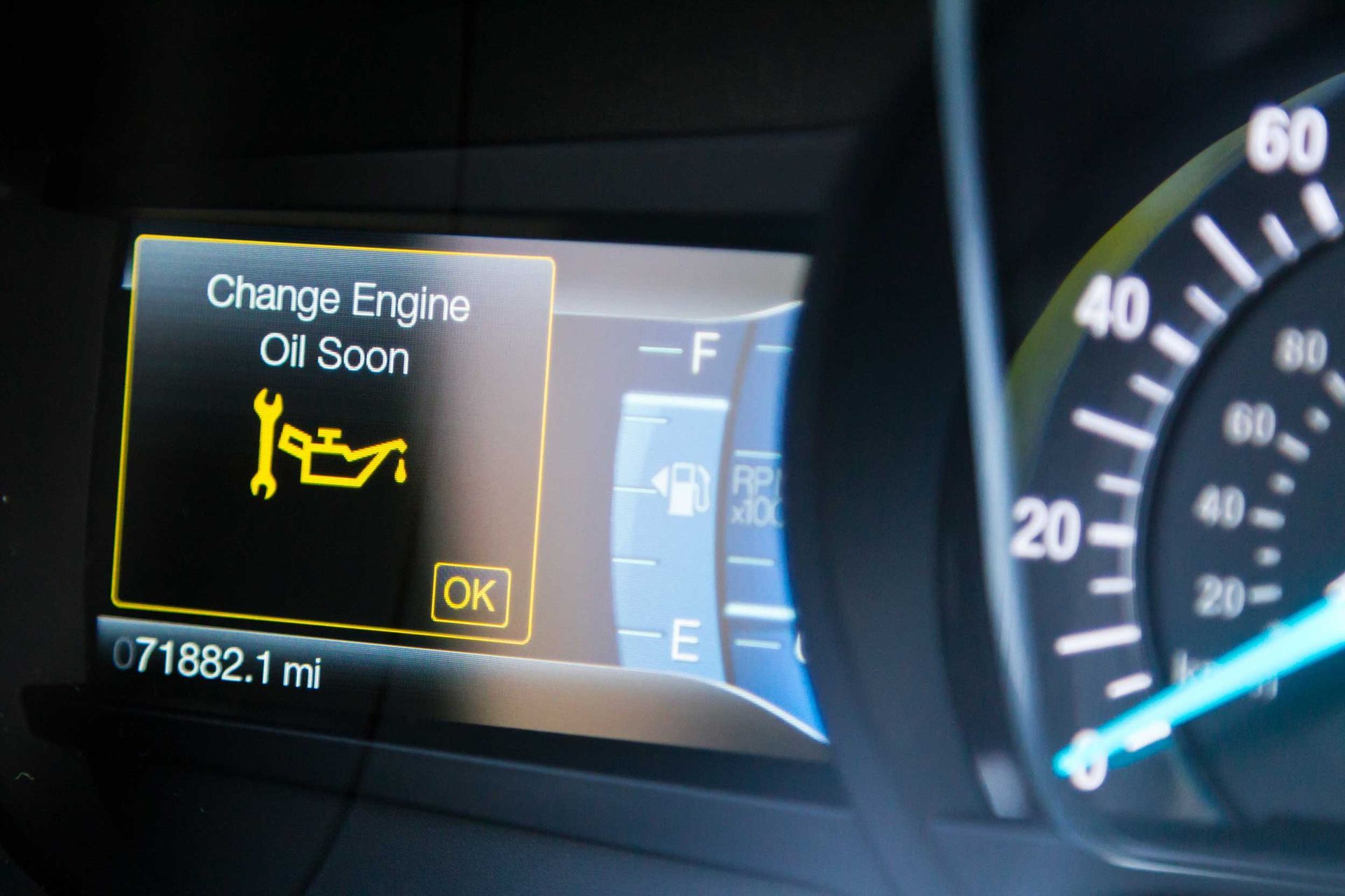 Engine oil service alert on dashboard, odometer 71,882 miles, fuel and speed gauges shown. Engine oil service alert on dashboard, odometer 71,882 miles, fuel and speed gauges shown.