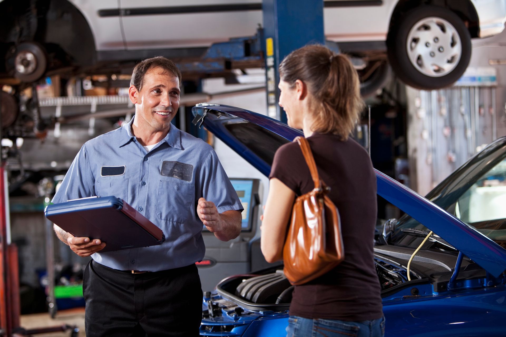 Trusted auto repair in Vandalia, OH: Elite Auto Experts LLC mechanic and customer reviewing car