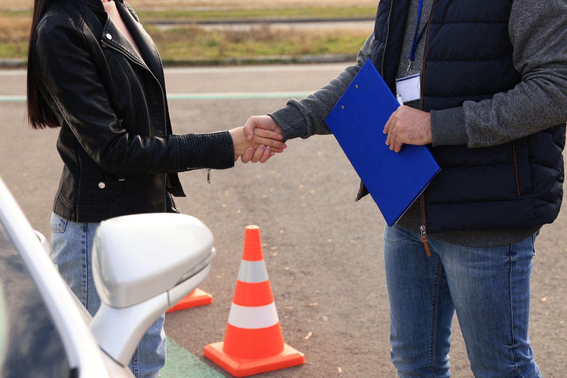 Two workers shaking hands on a newly paved road. Two workers shaking hands on a newly paved road.