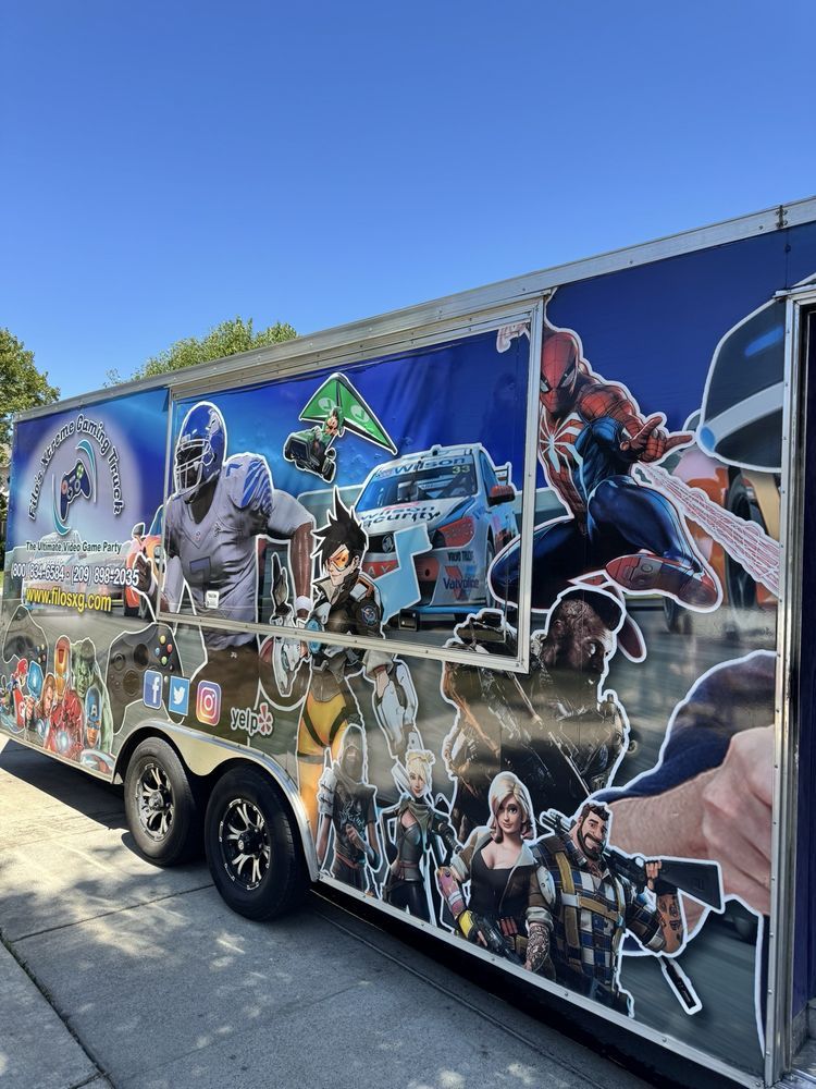 Gaming trailer covered in superhero and video game character decals.