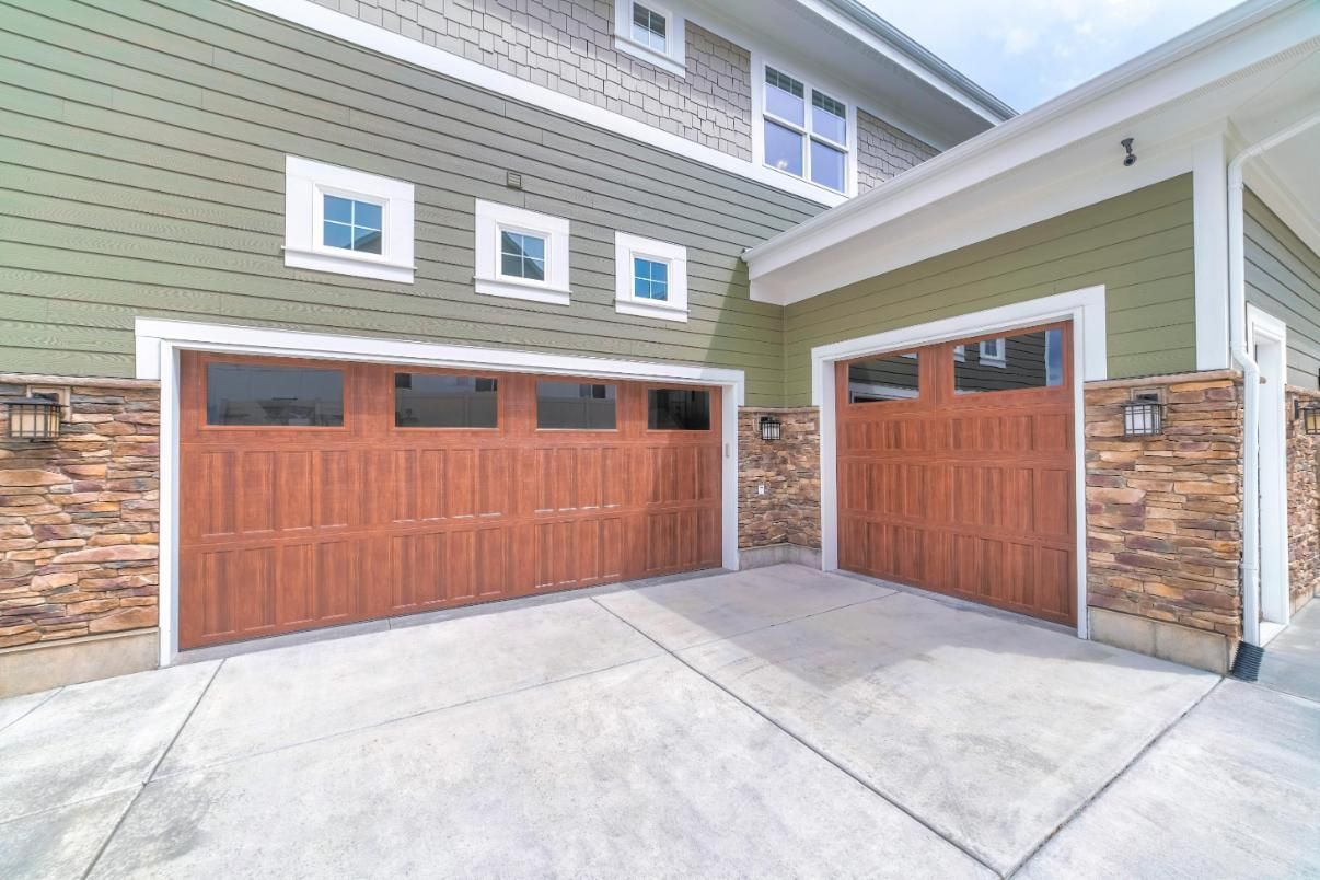 There Are Two Garage Doors On The Side Of A House — The Roller Door Man NQ In Port Douglas, QLD