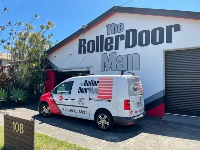 A Roller Door Man Van Is Parked In Front Of A Building — The Roller Door Man NQ In Portsmith, QLD
