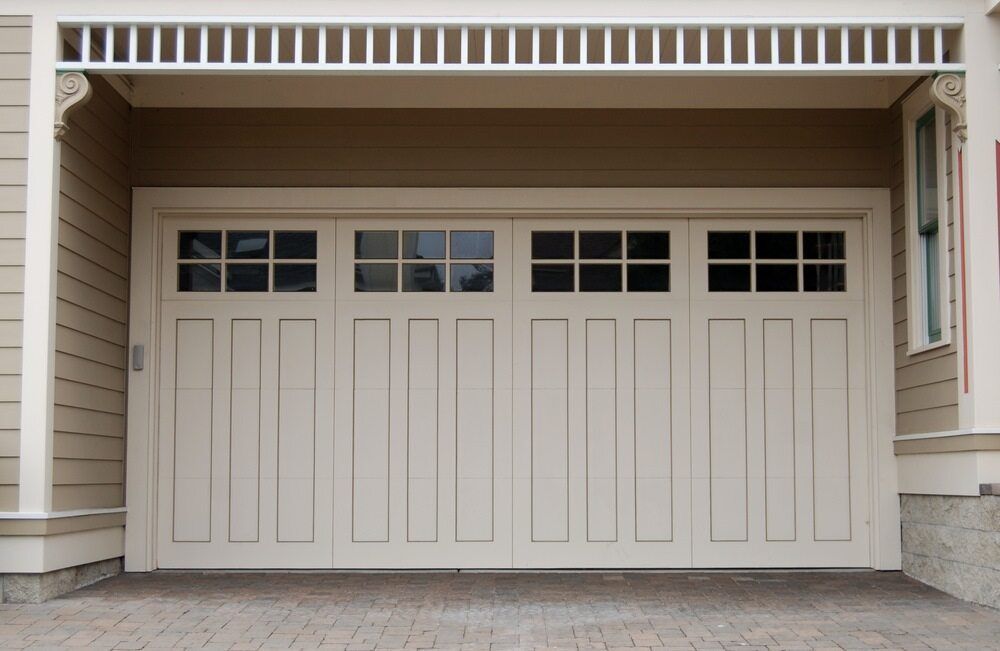 A White Garage Door With a Brick Driveway in Front of It — The Roller Door Man NQ In Gordonvale, QLD