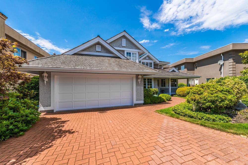 A Large House With A Large Garage And A Brick Driveway — The Roller Door Man NQ In Cairns, QLD