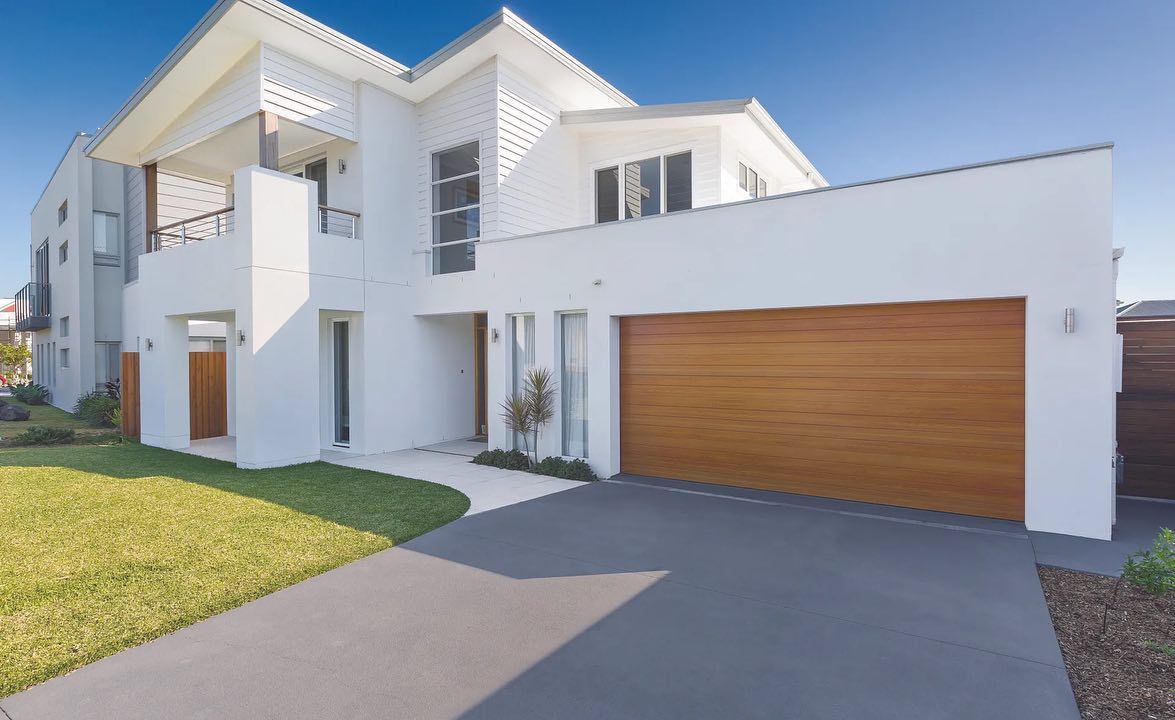 A Large White House With a Wooden Garage Door — The Roller Door Man NQ In Gordonvale, QLD
