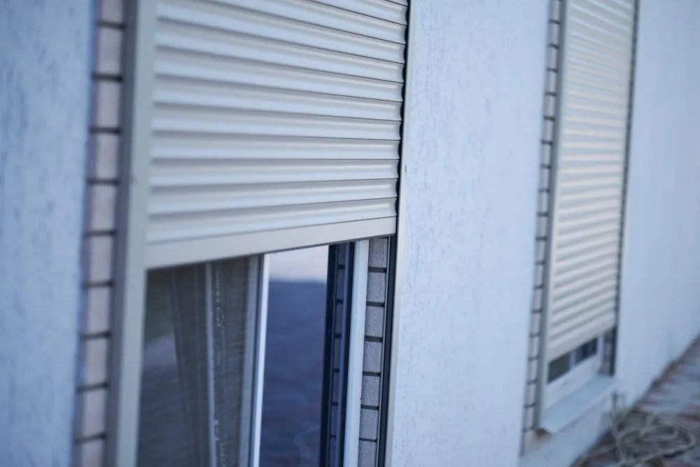 Beige Rolling Shutters Are Partially Closed — The Roller Door Man NQ In Portsmith, QLD