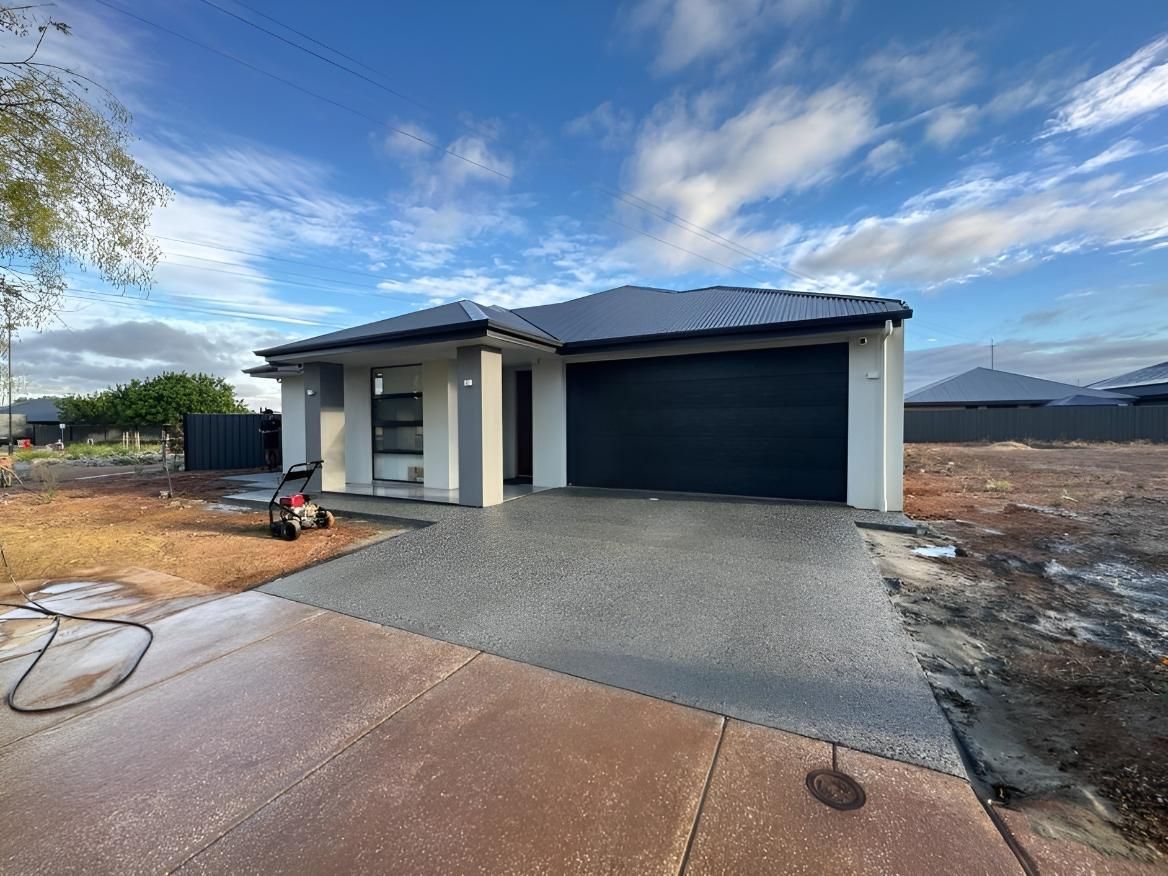 A House With A Garage And A Driveway In Front Of It — The Roller Door Man NQ In Port Douglas, QLD