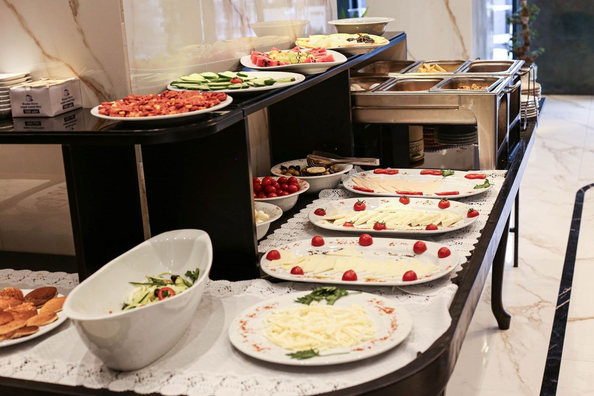 Buffet table with assorted dishes and salads in a bright dining area