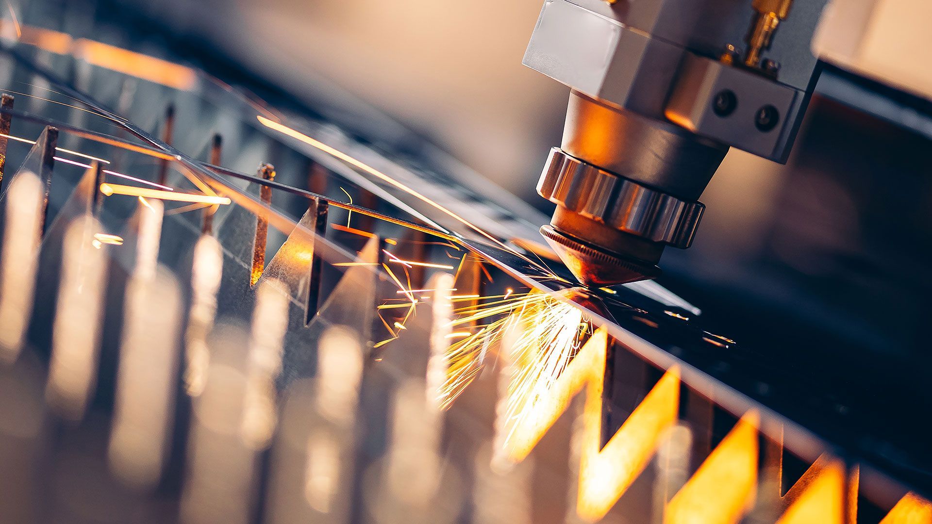 A laser cutting machine is processing a piece of metal.
