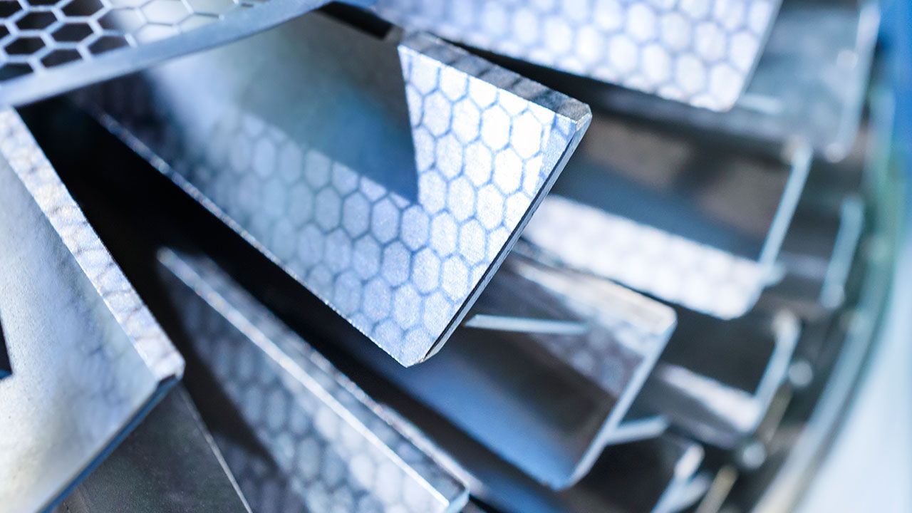 A close up of multiple metal parts with a beveled edge. 