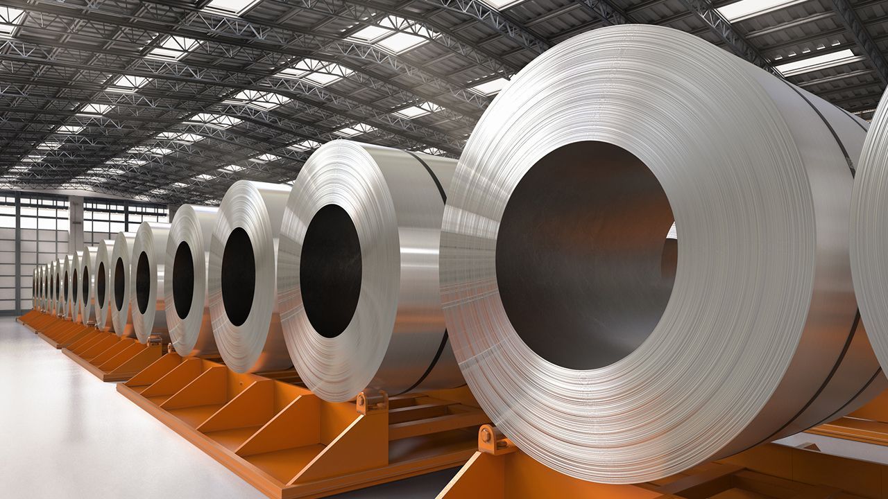 A row of steel coils in a warehouse.
