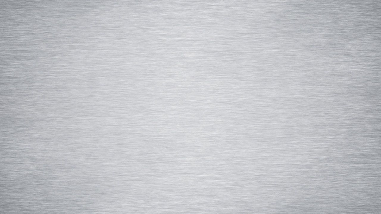 A close up of stainless steel with a brushed texture.
