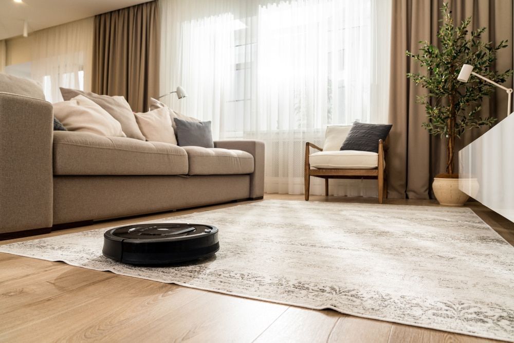 A Robot Vacuum Cleaner Is Cleaning A Rug In A Living Room —  Cabonne Carpets In Molong, NSW