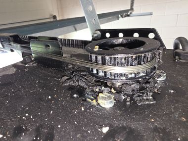 Ceiling-mounted garage door opener with bright built-in light and overhead track