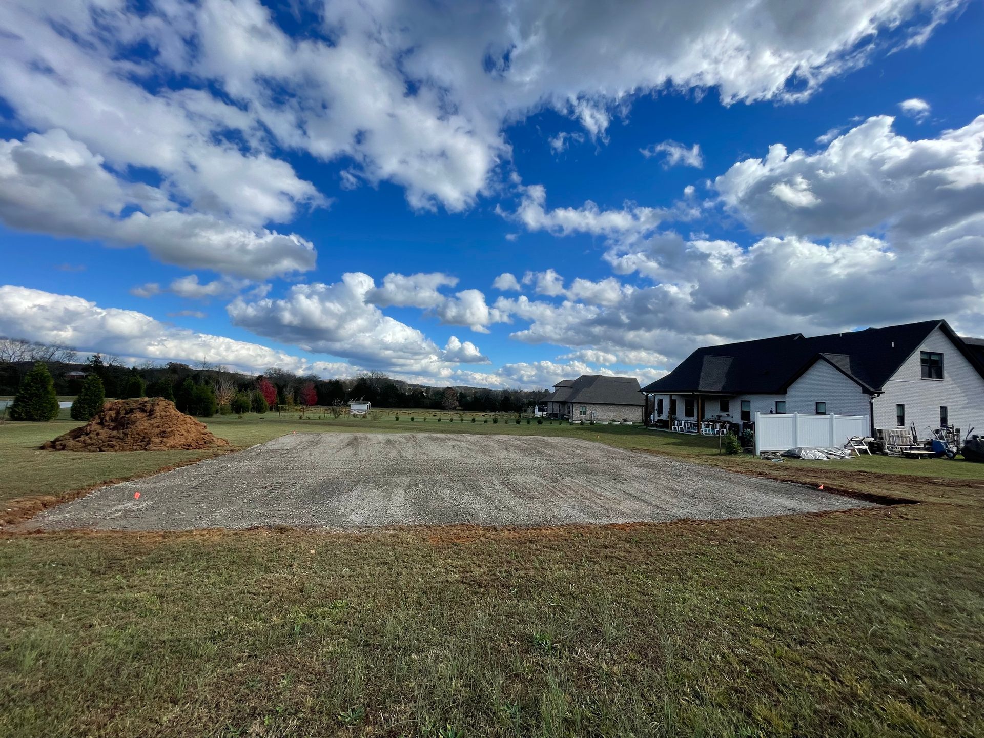 A large empty field with a house in the background.