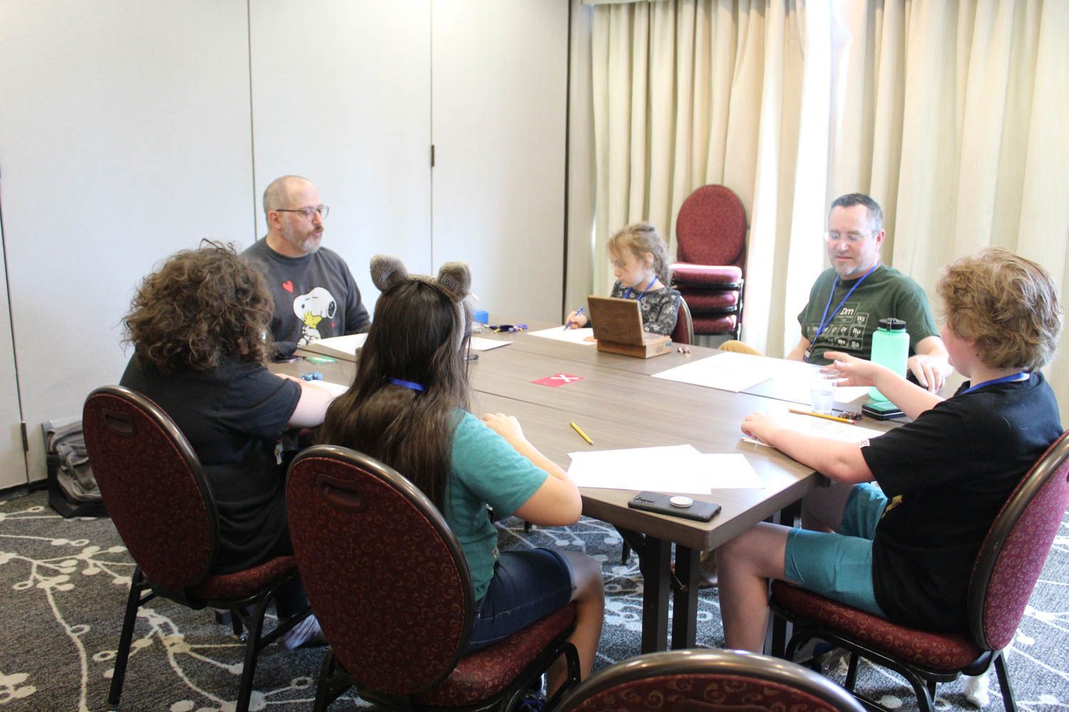 Families playing tabletop games together at a family gaming convention