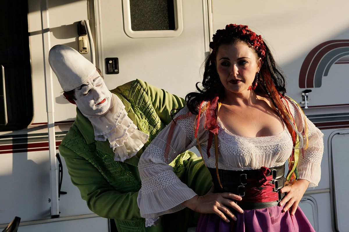 Jay jokingly struggles to help Tosca, his wife, into her costume before the show.