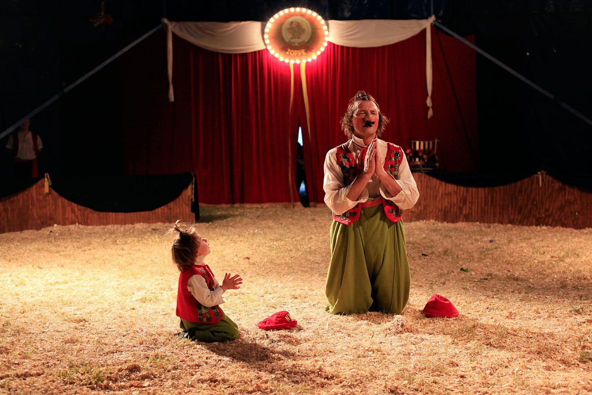Nino and his son Julien bury a broken balloon as part of their act during a performance in Oak Forest, Illinois.