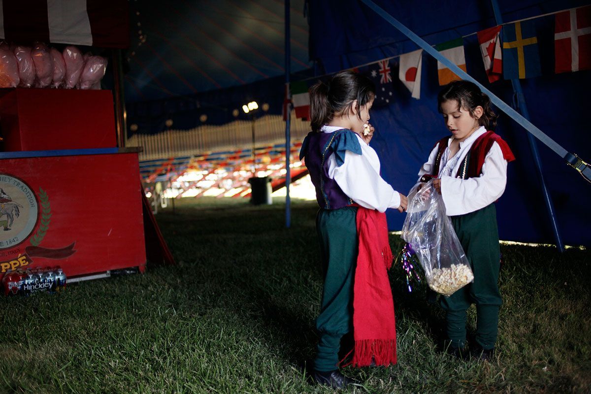The twins share popcorn before the show in Addison, Illinois.