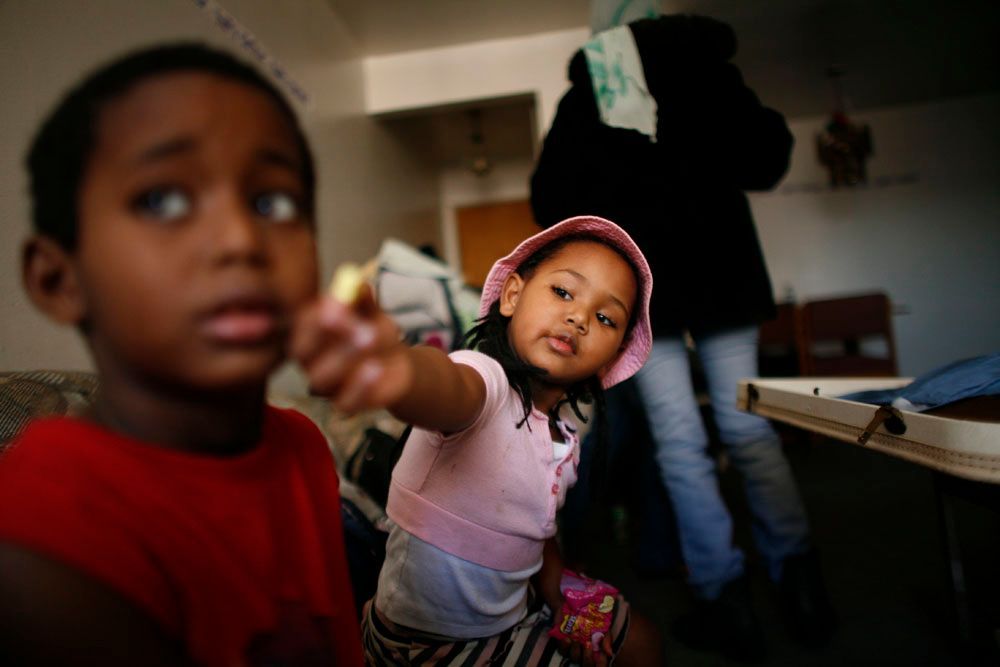 Kidan's kids play in the living room before Kidan goes to work.