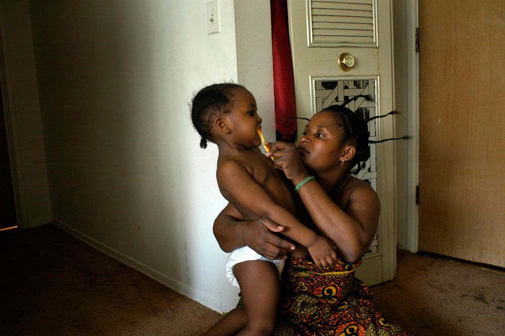 Asiya brushes Lelia’s teeth before heading to her English class. Asiya and her family came to the United States in February 2006 and are still learning the language, the school system, and the daily routine of living in Chicago.