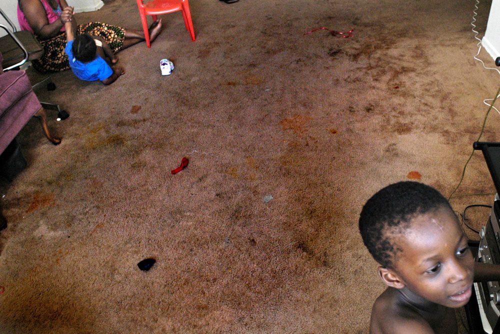 The Mambo family's apartment in Chicago was full of cockroaches and the walls were marked from past tenants. 'The bugs are everywhere,' said Aline. 'We could sometimes feel them in the bed.'