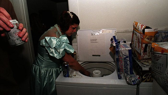 A washing machine serves as a container for ice and beer at Lancaster Prom on May 5, 2004. Lancaster Prom is a street party thrown by members of the 'hipster crowd' at Ohio University. The prom was held as an alternative to more traditional street parties held in Athens, Ohio.