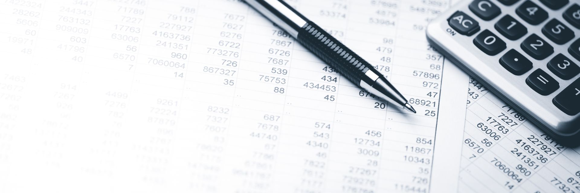 A pen, calculator, and financial documents, suggesting accounting or budgeting tasks.