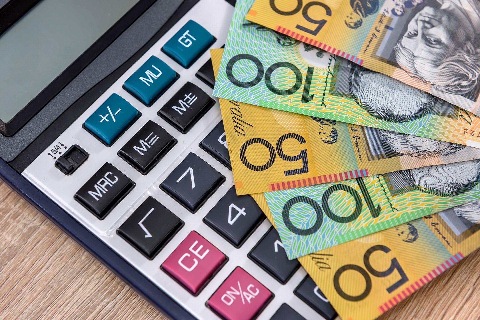 Calculator with Australian $50 and $100 banknotes. Calculator with Australian $50 and $100 banknotes.