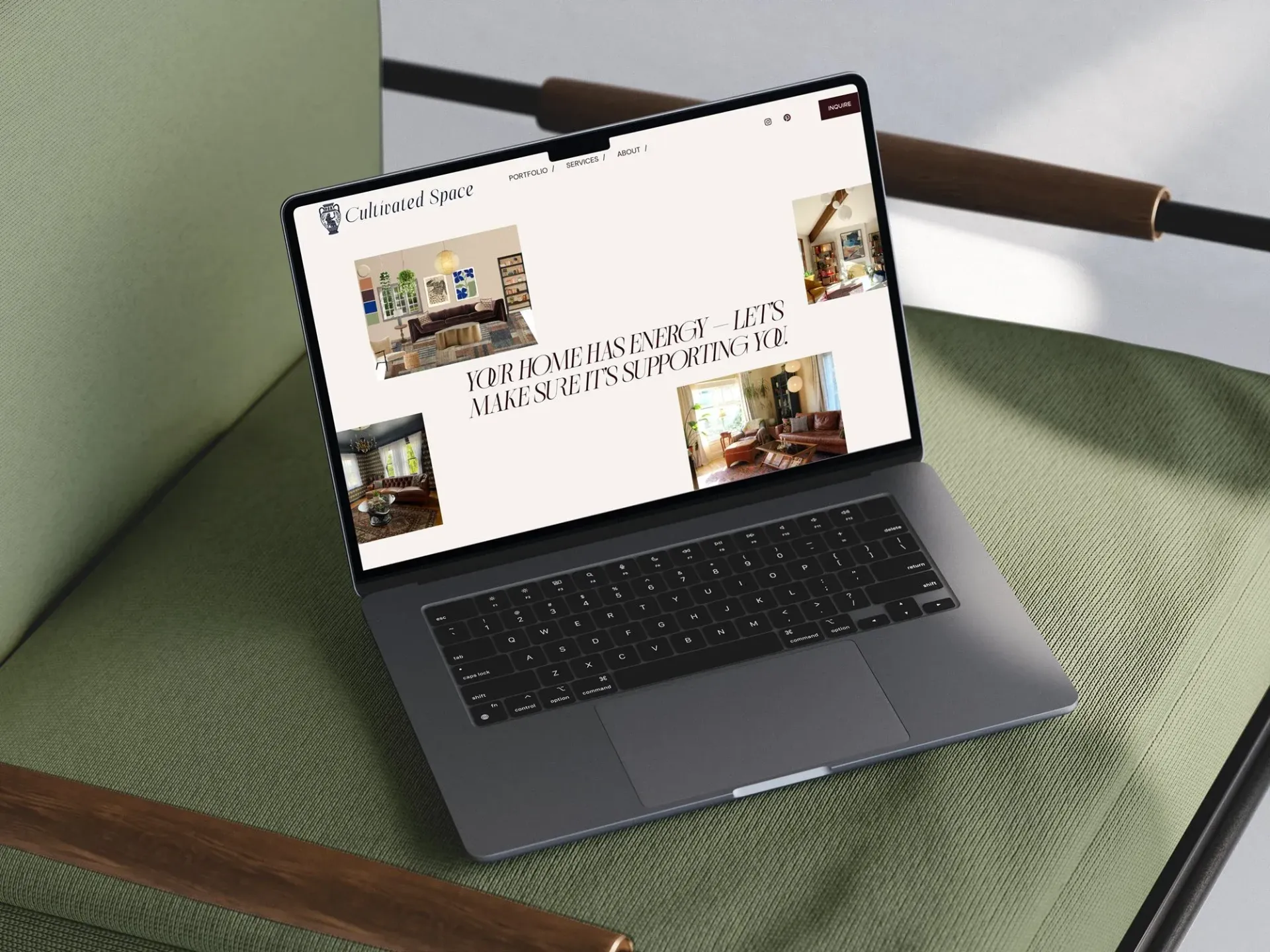 Laptop displaying a website with interior design photos on a green chair with a wooden frame.